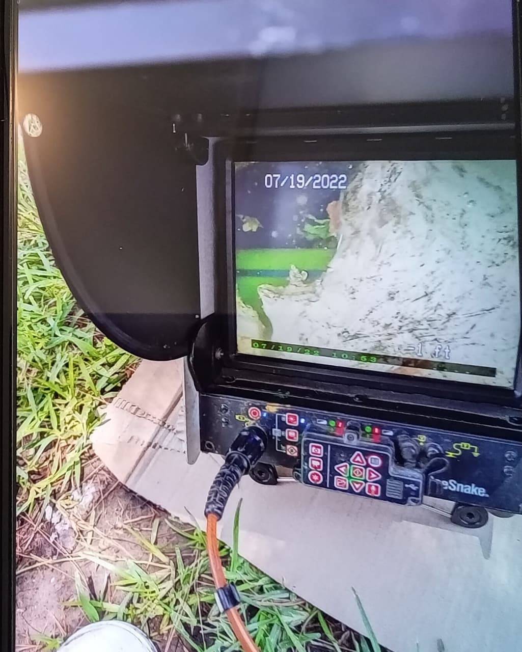 Drain camera monitor displaying live inspection footage from inside a pipe